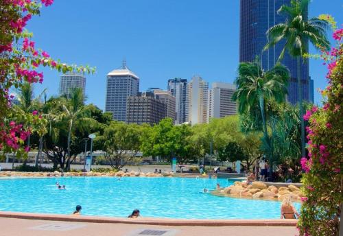 a large swimming pool with a city skyline in the background at Amazing City Location-Private Room in a Share House-2 Rooms available!! in Brisbane