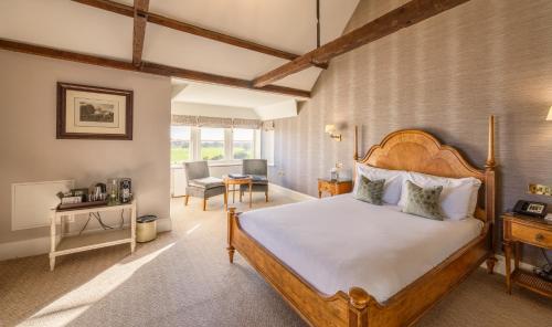 a bedroom with a large bed in a room at Wivenhoe House Hotel in Colchester