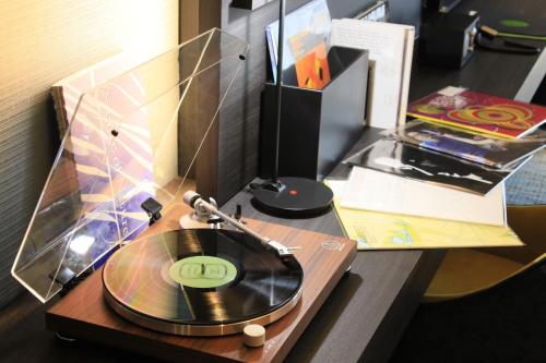 a record player on a table with a cd at Richmond Hotel Premier Kyoto Shijo in Kyoto