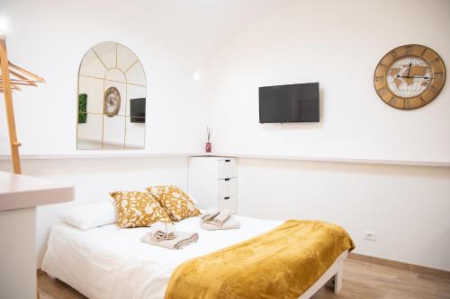 1 dormitorio con 1 cama y reloj en la pared en Locazione Turistica- Maxxi loft en Roma