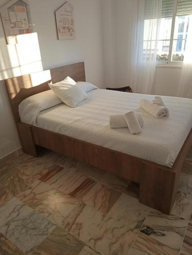 a bedroom with a bed with two towels on it at Sevilla BRISAS VIP Valencina de la concepción in Seville