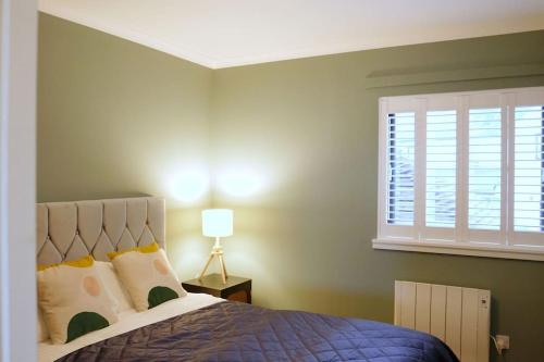 a bedroom with a large bed and a window at Seaside Apartment in Largs