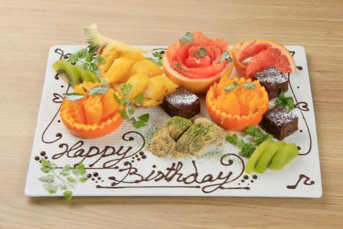 a plate of food with fruits and vegetables on a happy birthday at Richmond Hotel Premier Kyoto Shijo in Kyoto