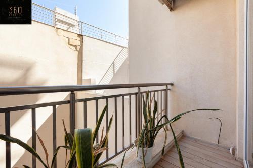 a balcony with a railing and a plant at Lovely 2BR home in St Julians with Private Balcony by 360 Estates in St Julian's