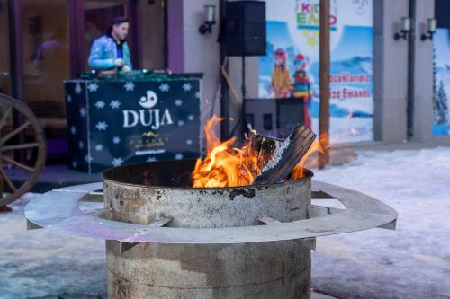 a fire in a pot on the side of a street at Duja Chalet Ski Center in Sarıkamıs