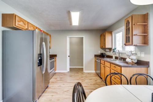 a kitchen with wooden cabinets and a stainless steel refrigerator at McGaheysville Vacation Rental, 1 Mi to Skiing! in McGaheysville