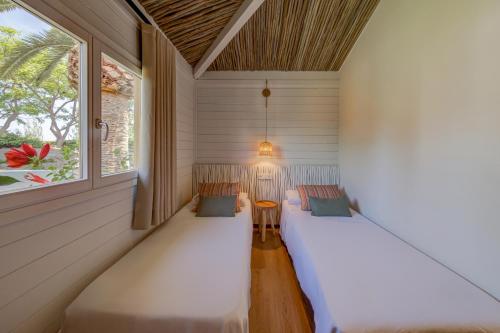 a small room with two chairs and a window at Sangulí Camping & Resort in Salou