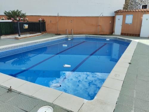 a swimming pool with blue water at Apartamento Alameda Ezcaray, piscina y ascensor in Ezcaray