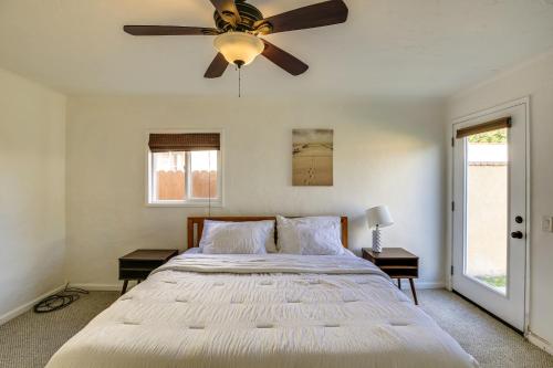 a bedroom with a large bed with a ceiling fan at Spanish-Style Long Beach Bungalow Near Beaches! in Long Beach