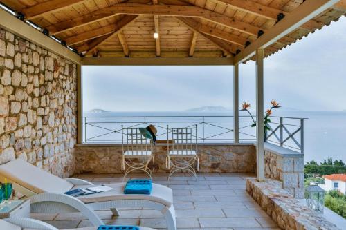 a patio with a view of the ocean at Infinite Blue Epidavros in Ancient Epidavros