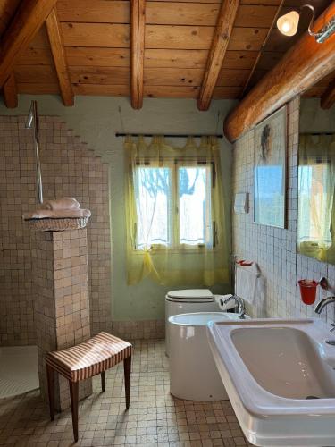 a bathroom with a tub and a toilet and a sink at Palazzo delle Biscie - Old Tower & Village in Molinella