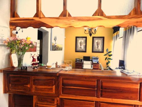 an office with a wooden desk with a mirror at Longtom Farm Guesthouse in Lydenburg