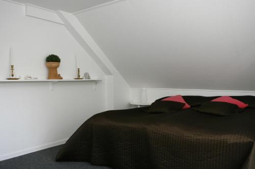 a bedroom with a bed with a black comforter at Café Torpet B&B in Skepplanda