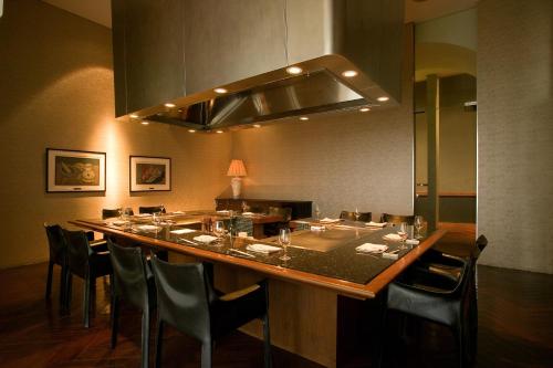 a dining room with a long table and chairs at Hakone Hotel in Hakone