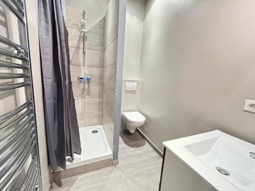 a bathroom with a shower and a toilet and a sink at 7Art Hotel in Cannes