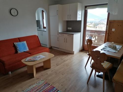 a living room with a couch and a table at Embacher Marianne - Rotharlhof in Hopfgarten im Brixental