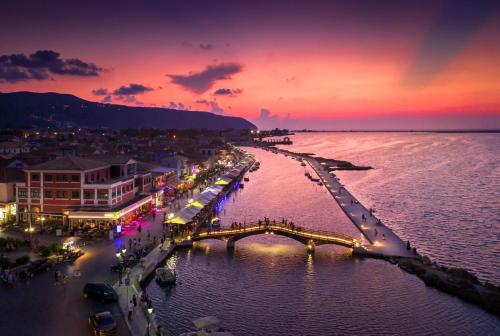 a city with a bridge over the water at night at YANNIS RETREAT in Lefkada Town