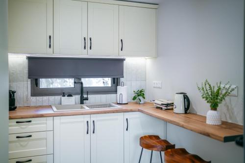 a kitchen with white cabinets and a counter top at YANNIS RETREAT in Lefkada Town