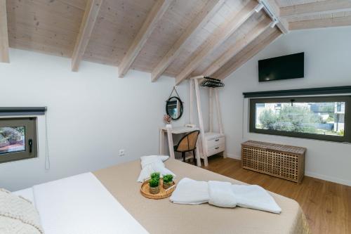 a bedroom with a large bed with two pillows at YANNIS RETREAT in Lefkada Town