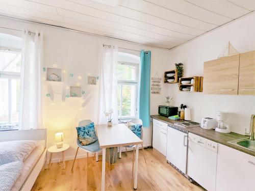a kitchen with a table and a bed in a room at H1 - Urlaubsmagie - Pool & Terrasse zum Entspannen in Sebnitz