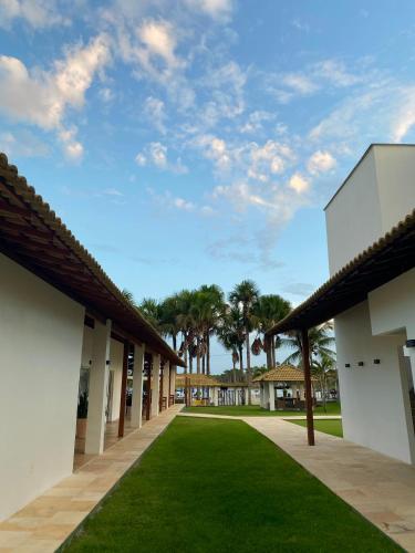 a view of the courtyard of a building with green grass at Lagoa do Cassó - Pousada Porto do Cajú in Caçozinho