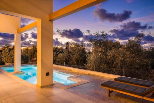a view of a swimming pool from a house at Karma - Unalome Villas in Andipáta Erísou