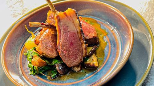 a bowl of food with meat and vegetables on a table at The Crown Inn at Benson in Wallingford