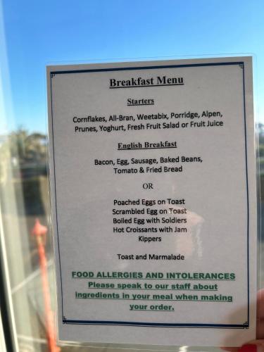 a sign in the window of a restaurant at Marine Hotel in Paignton