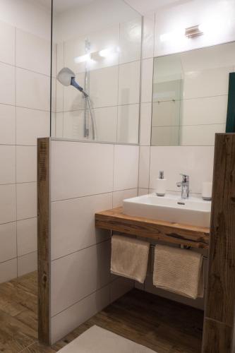 a bathroom with a sink and a mirror at Krumbacherhof in Krumbach Markt