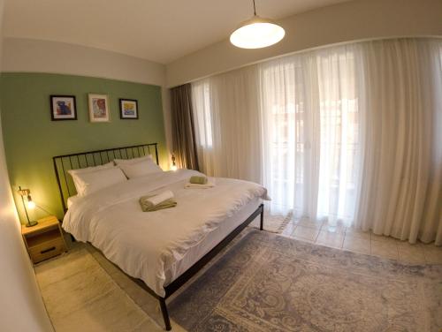 a bedroom with a bed and a large window at Scala Room 68 in Ioannina