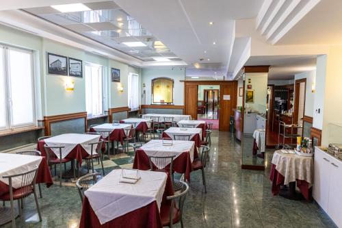 a restaurant with tables with red and white tablecloths at Hotel Mary in Vicenza