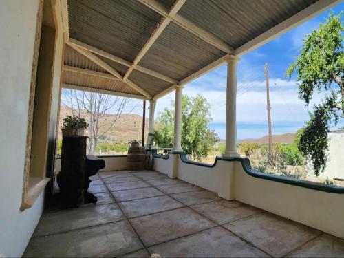 an empty porch with a view of the desert at Magoos on 62 in Ladismith