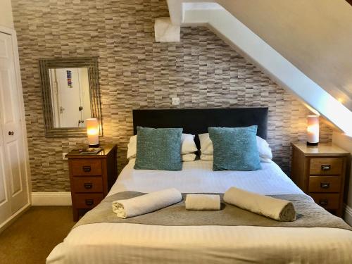 a bedroom with a large bed with pillows on it at Ravensworth House in Keswick