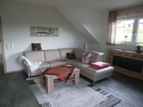 a living room with a couch and a table at Wiesenblick in Brilon