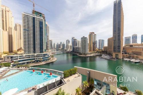 a view of a river in a city with buildings at Exclusive Newly Renovated 1BR full Marina views in Dubai