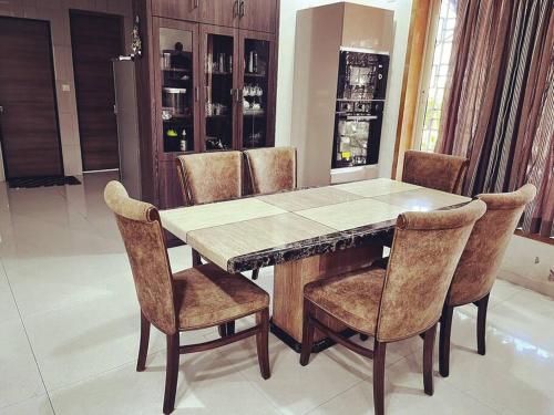 a dining room table and chairs in a room at D Villa : A posh bunglow with modern amenities in Panaji