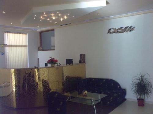 a living room with a couch and a table at Hotel Gazei in Bansko