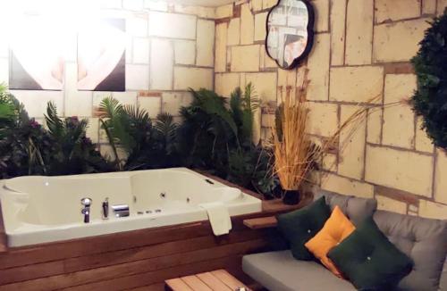 a bath tub in a room with plants at TNR Otel & Spa in Kusadası