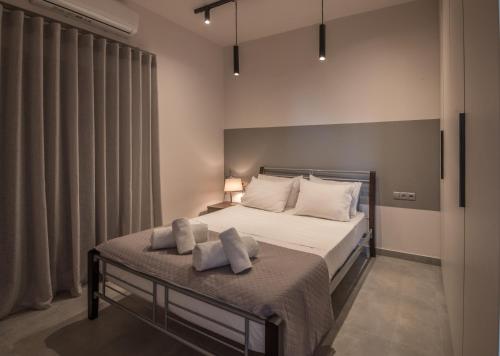 a bedroom with a bed with two pillows on it at Valeria's Sea View Apartment in Athens