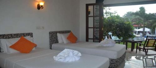 Postelja oz. postelje v sobi nastanitve New Sithi Villas