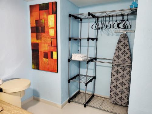a bathroom with a towel rack next to a toilet at Chic 3 Bedroom Unit, Few Steps To The Ocean, Barbosa Unit 4 in Catano