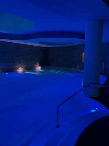a dark room with a blue light in a room at Bes Hotel Terme a Palazzago in Palazzago
