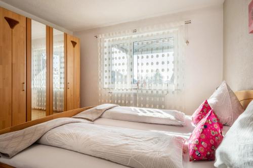 a bedroom with a large bed with a window at Ferienwohnung Lichtblick in Friedrichshafen