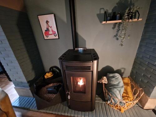 a wood burning stove in a living room at Villa Simone in Spa