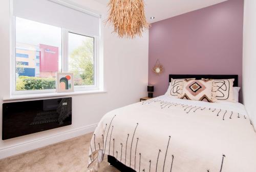 a bedroom with a bed and a fireplace at Railway Apartments Rugby in Rugby