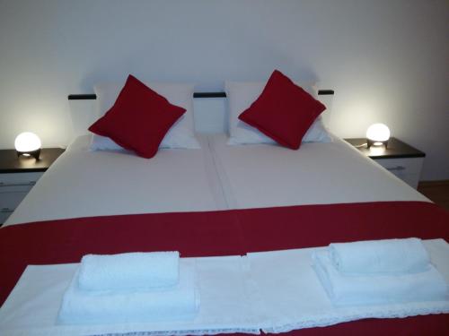 a bedroom with a large bed with red pillows at Apartments Vucetic in Hvar