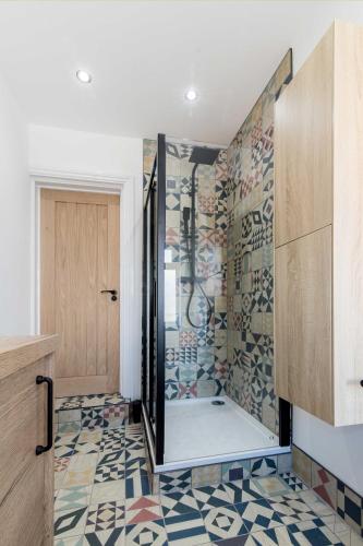 a bathroom with a shower with a glass door at Railway Apartments Rugby in Rugby