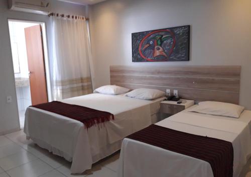 Ένα ή περισσότερα κρεβάτια σε δωμάτιο στο Hotel Sol Nascente