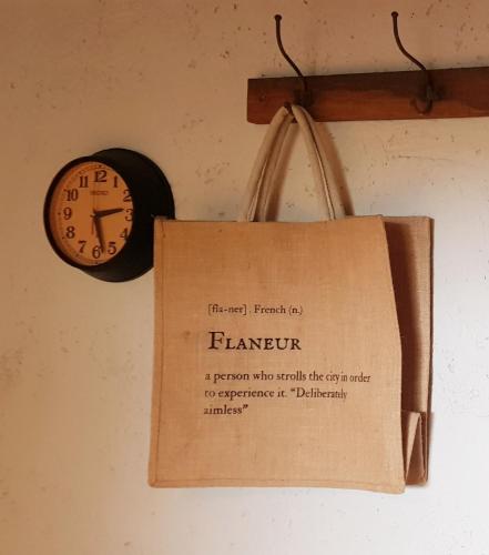 a paper bag and a clock on a wall at Le Lodge des Flâneurs in Vielsalm