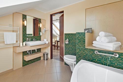 a bathroom with a white toilet and a sink at Hotel Bonum Old Town in Gdańsk